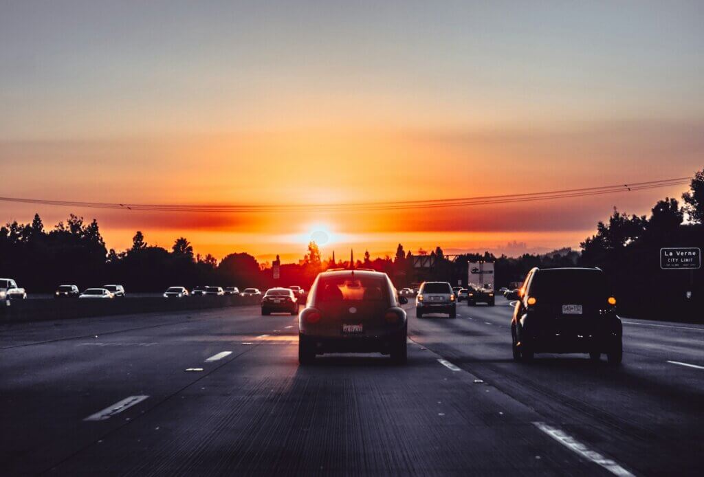 cars on freeway during sunset